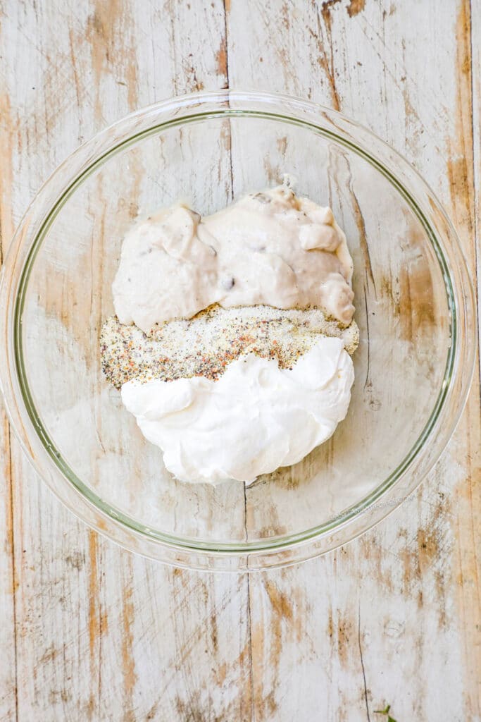 How to make cream of mushroom chicken casserole step 2: Mix the Campbell's cream of mushroom soup, sour cream, and seasonings together.