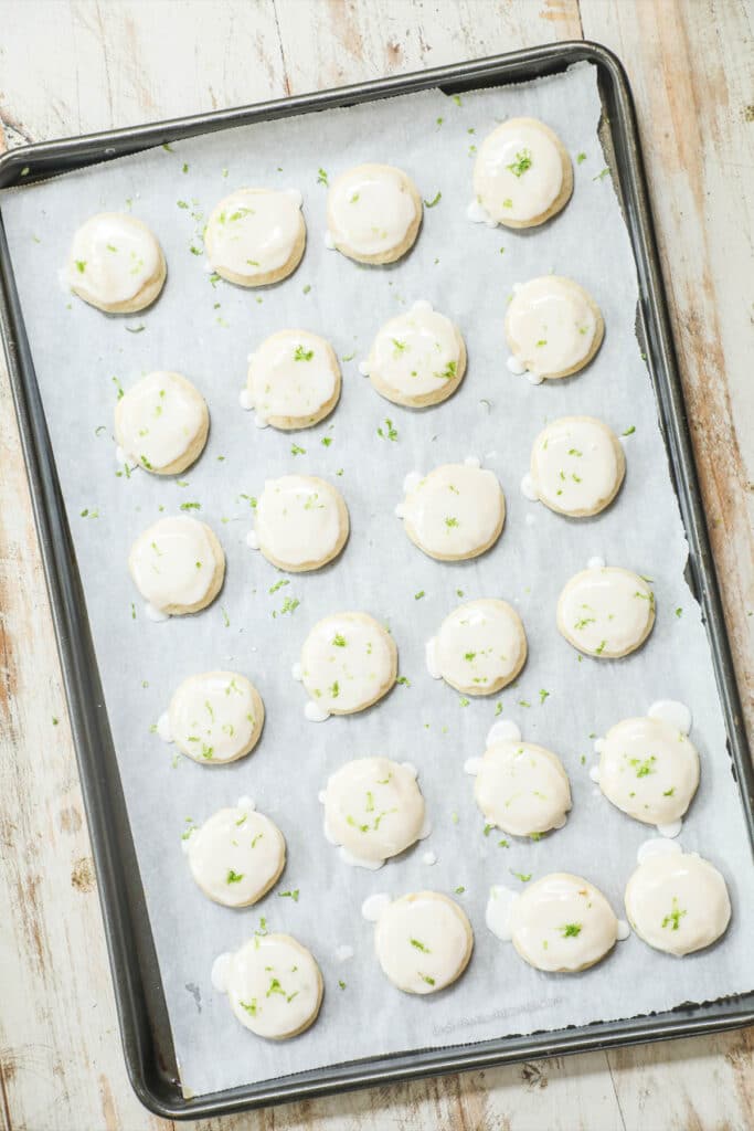 How to make key lime cookies step 5. Dip the tops of the cookies in the glaze , then garnish with lime zest.