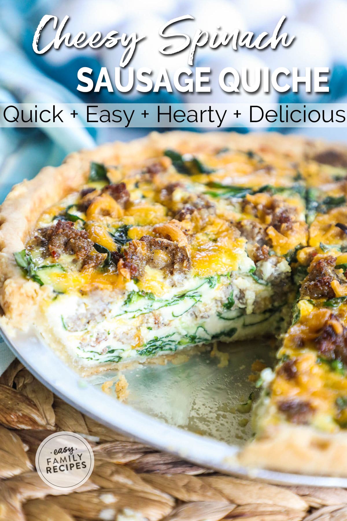 Slice of sausage spinach quiche with fresh spinach