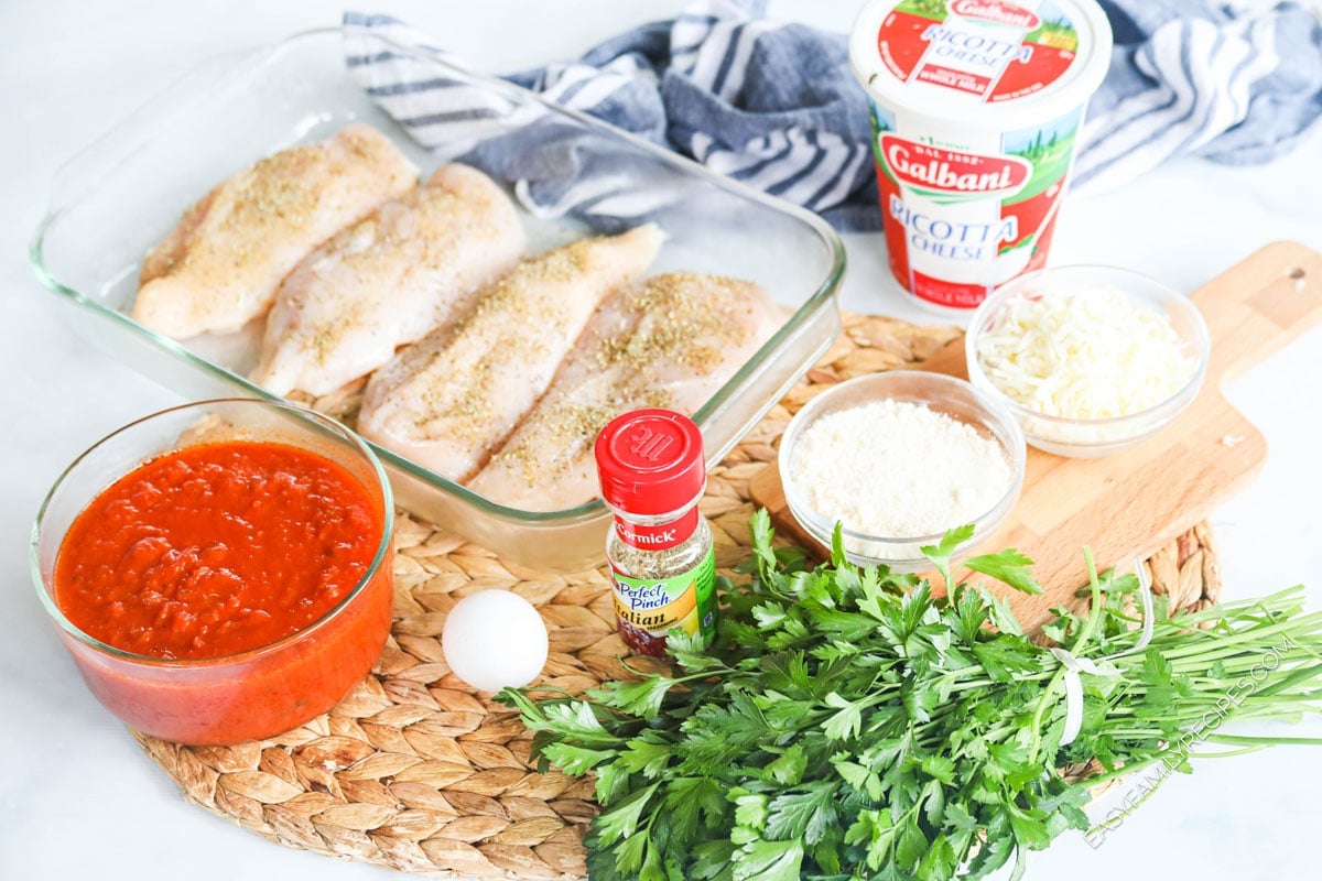 Ingredients for making Lasagna Chicken - Chicken breast, tomato sauce, seasonings, parsley, ricotta cheese, egg, mozzarella cheese