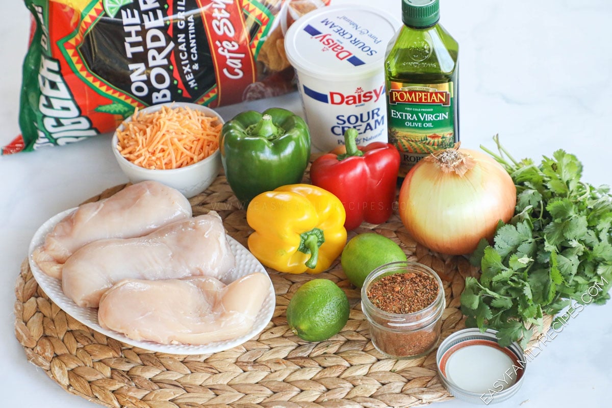 Chicken Fajita Nachos Ingredients including chicken breast, bell pepper, onion, chips, lime, cheese, sour cream