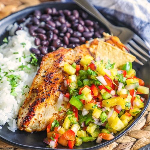 Seared chicken breast with pineapple salsa served with cilantro lime rice and black beans