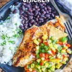 Seasoned Chicken breast with pineapple salsa served with rice and beans