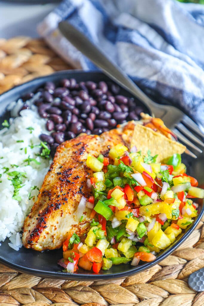 Seasoned Chicken breast with pineapple salsa served with rice and beans