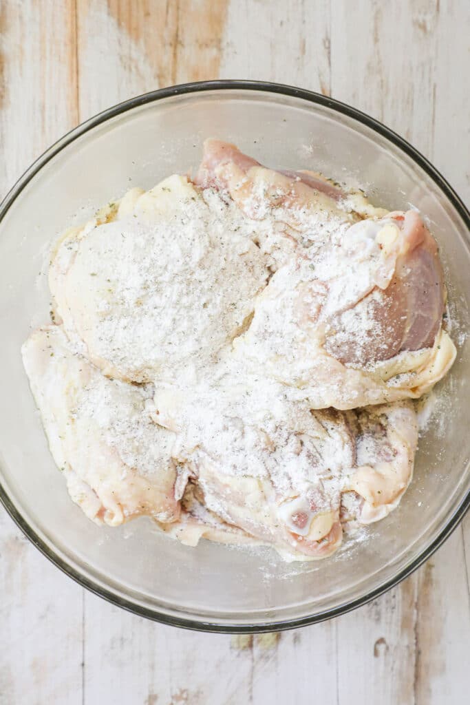 How to make ranch baked chicken thighs step 2: season with ranch seasoning packet and toss until the chicken thighs are coated on all sides with ranch seasoning.
