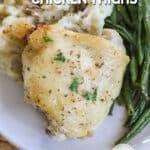 CLose up of ranch baked chicken thigh on a dinner plate.
