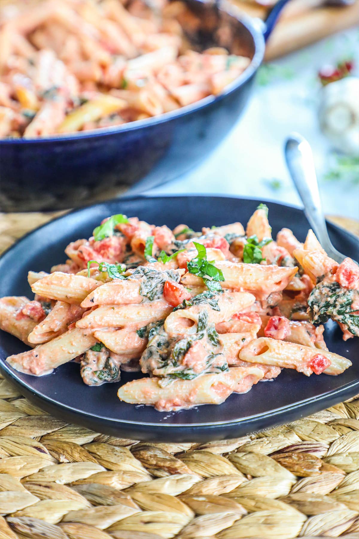 A plate filled with tomato basil pasta.