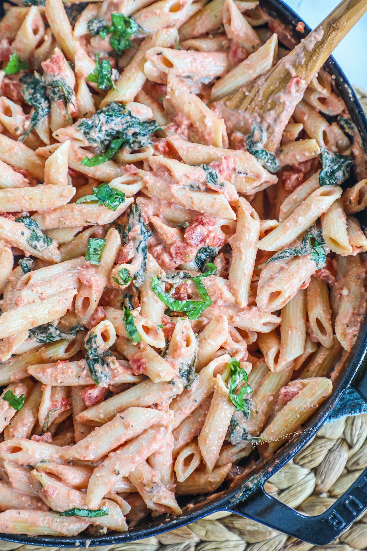 Close up of tomato basil pasta in a skillet.