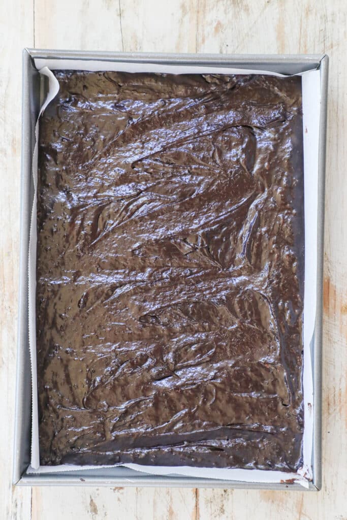 Step by step for making fudge brownies from scratch: 2. Spread in pan and bake.