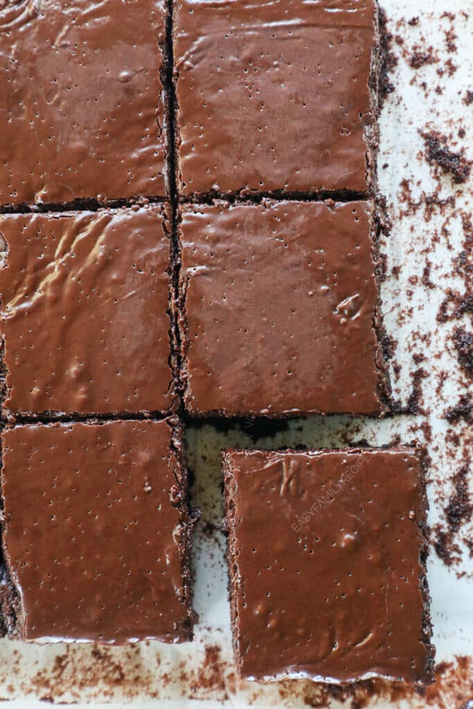 Step by step for making fudge brownies from scratch: 4. Spread frosting on brownies, cut and serve.