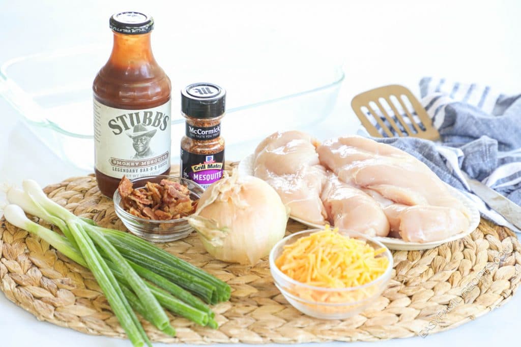 Ingredients for making Mesquite Chicken bake including chicken breast, mesquite seasoning, bbq sauce, green onions, bacon