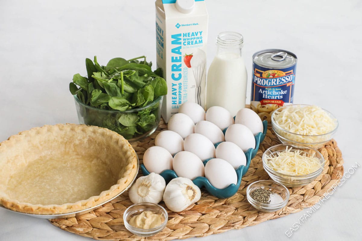 Ingredients for Spinach artichoke Quiche recipe including: pie crust, eggs, cream, fresh spinach, artichokes, cheese, mustard, salt and pepper