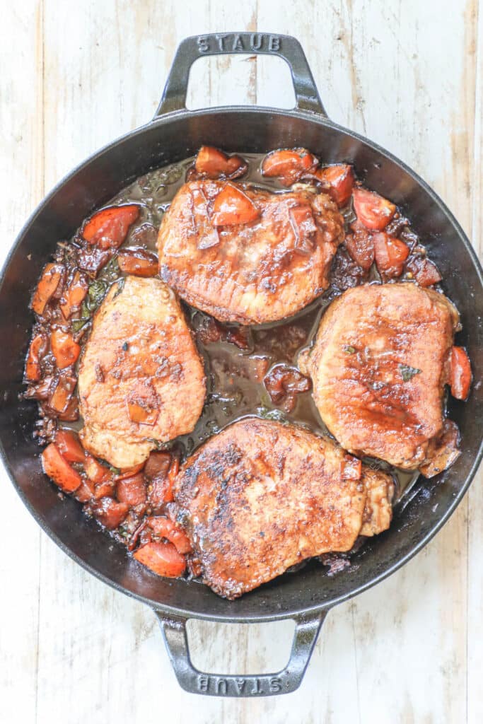 How to make Tuscan Pork Chops step 3: add pork chops back into pan and cook until done.