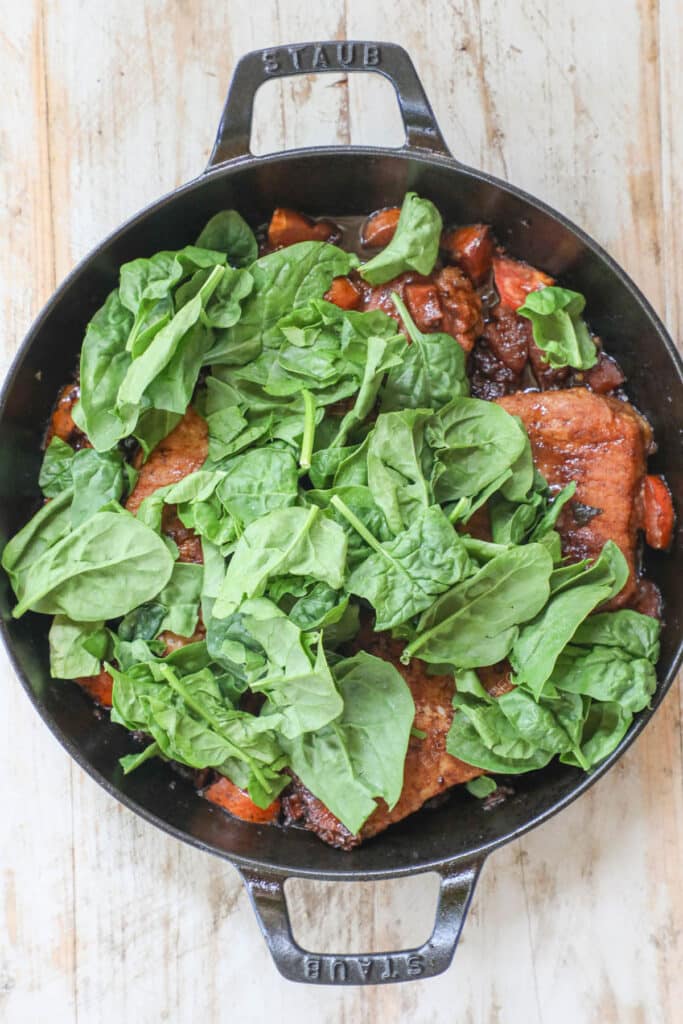 How to make Tuscan Pork Chops step 4: Stir in spinach until wilted.