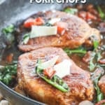 Tuscan pork chops with spinach and parmesan on top.