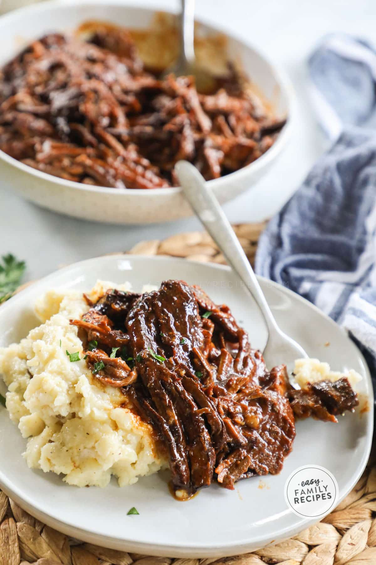 Crockpot Brisket served with mashed potatoes on a dinner plate