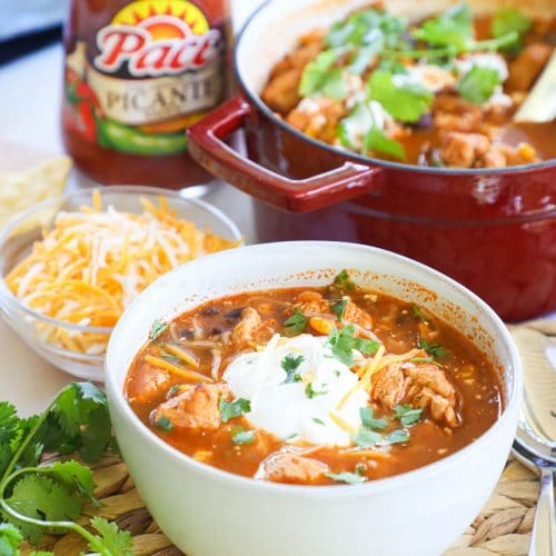 Chicken Salsa Soup served in a bowl topped with sour cream