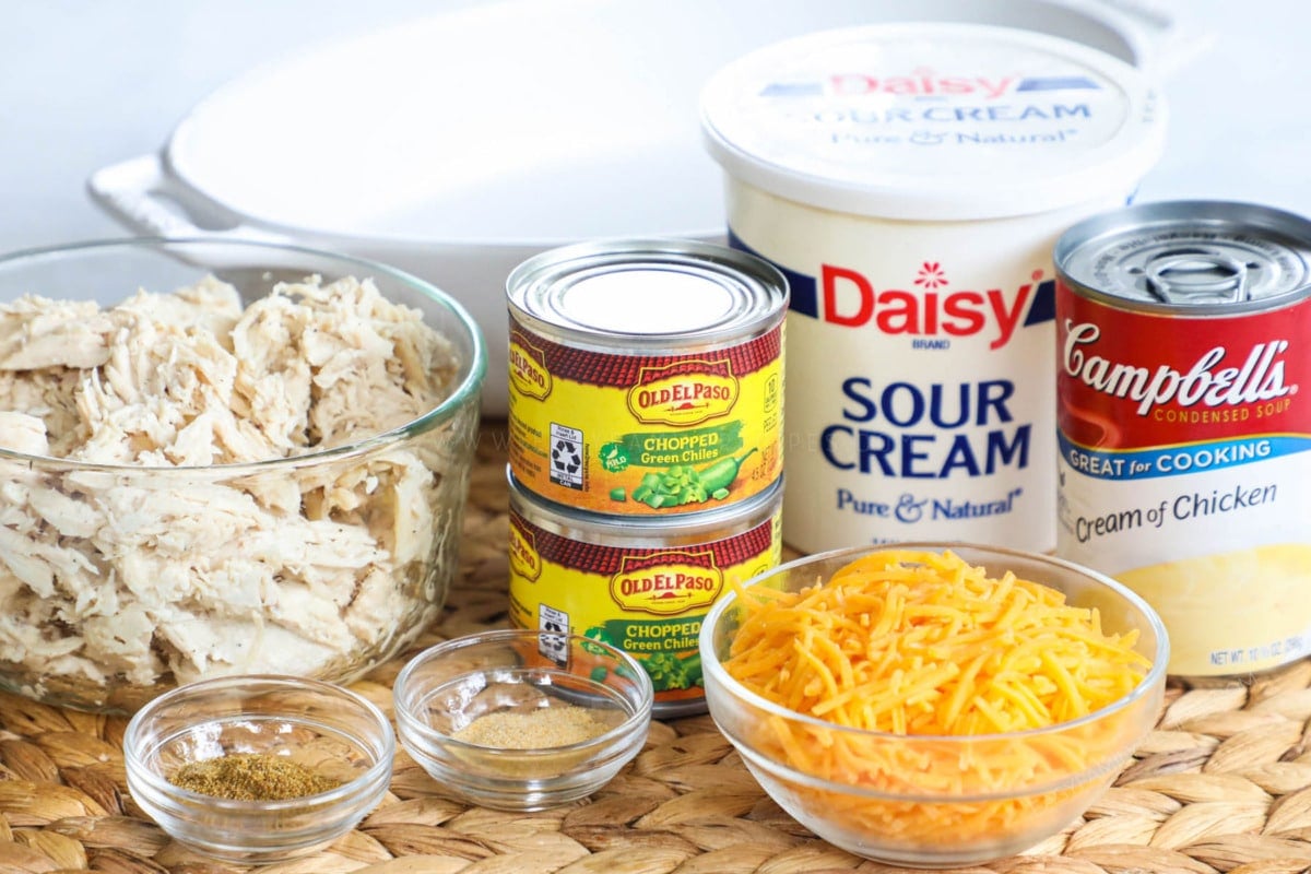Ingredients for green chile chicken casserole including rotisserie chicken, green chiles, sour cream, cream of chicken soup, cheddar cheese