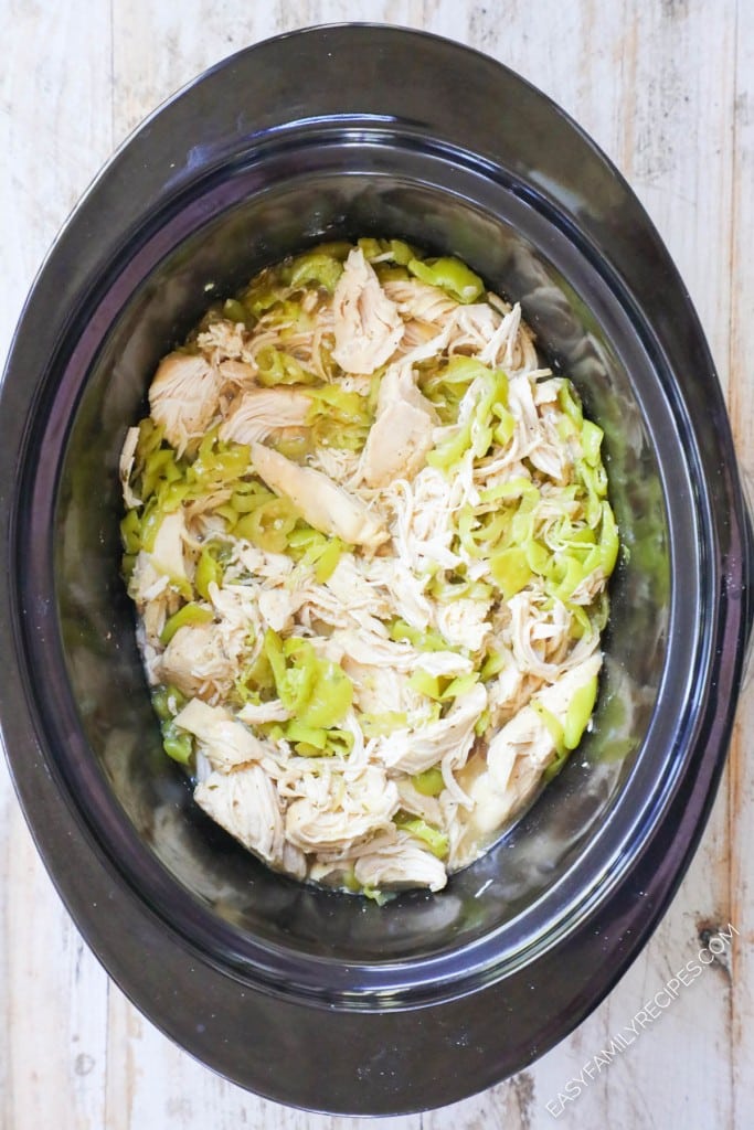 How to make Mississippi Chicken in crockpot Step 4: Shred the chicken breast and mix into the juices in the slow cooker.