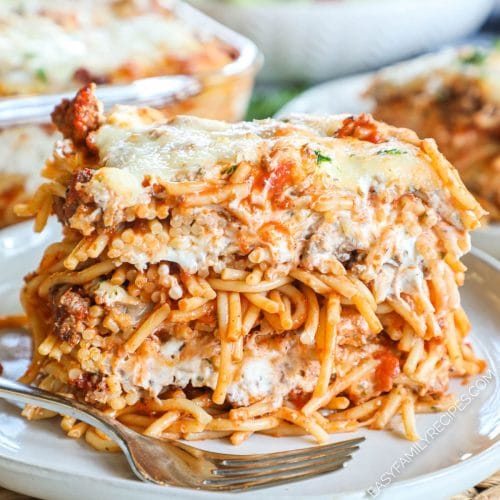 Serving of Million Dollar Spaghetti showing layers of cheese, meat, red sauce, and spaghetti