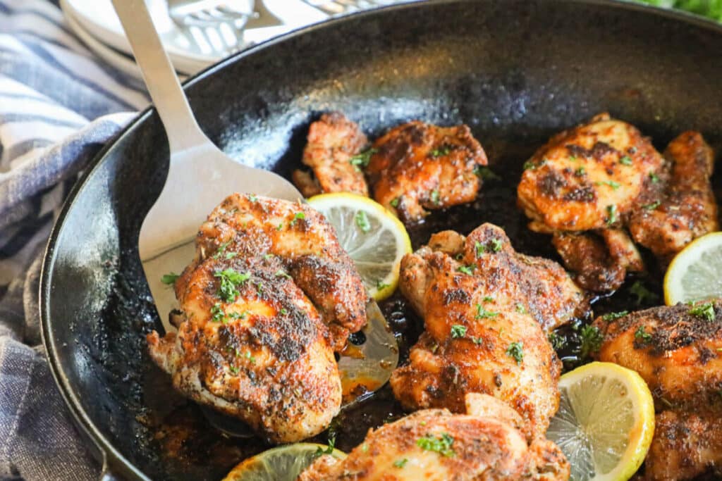 Blackened Chicken Thigh recipe prepared in cast iron pan.