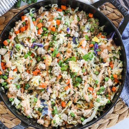 stir fried ground turkey with cabbage and frozen vegetables in a skillet