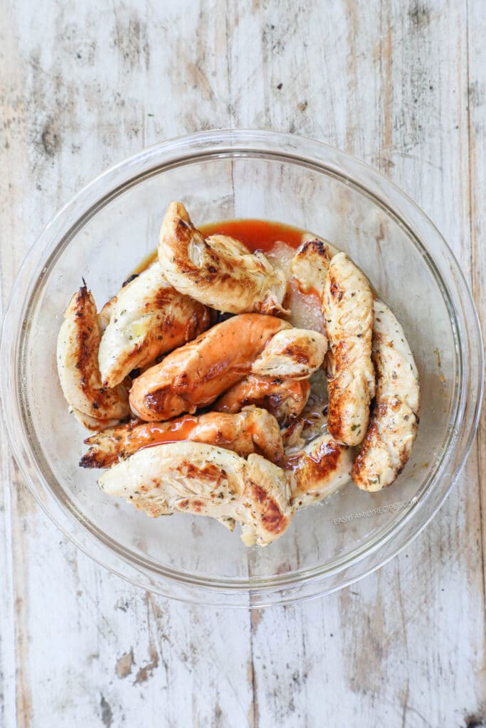 How to make Buffalo Chicken Tenders with no breading step 5: toss chicken tenderloins with buffalo sauce.