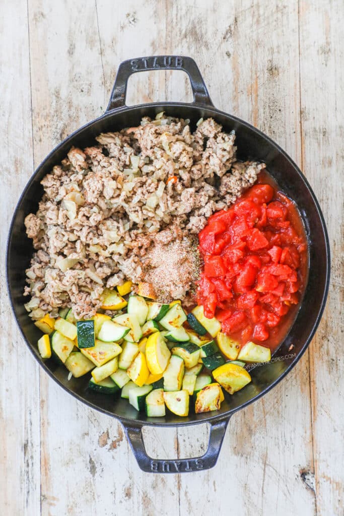 How to make Italian Ground Turkey Skillet Step 2: Cook the ground turkey then add tomatoes and sasonings.