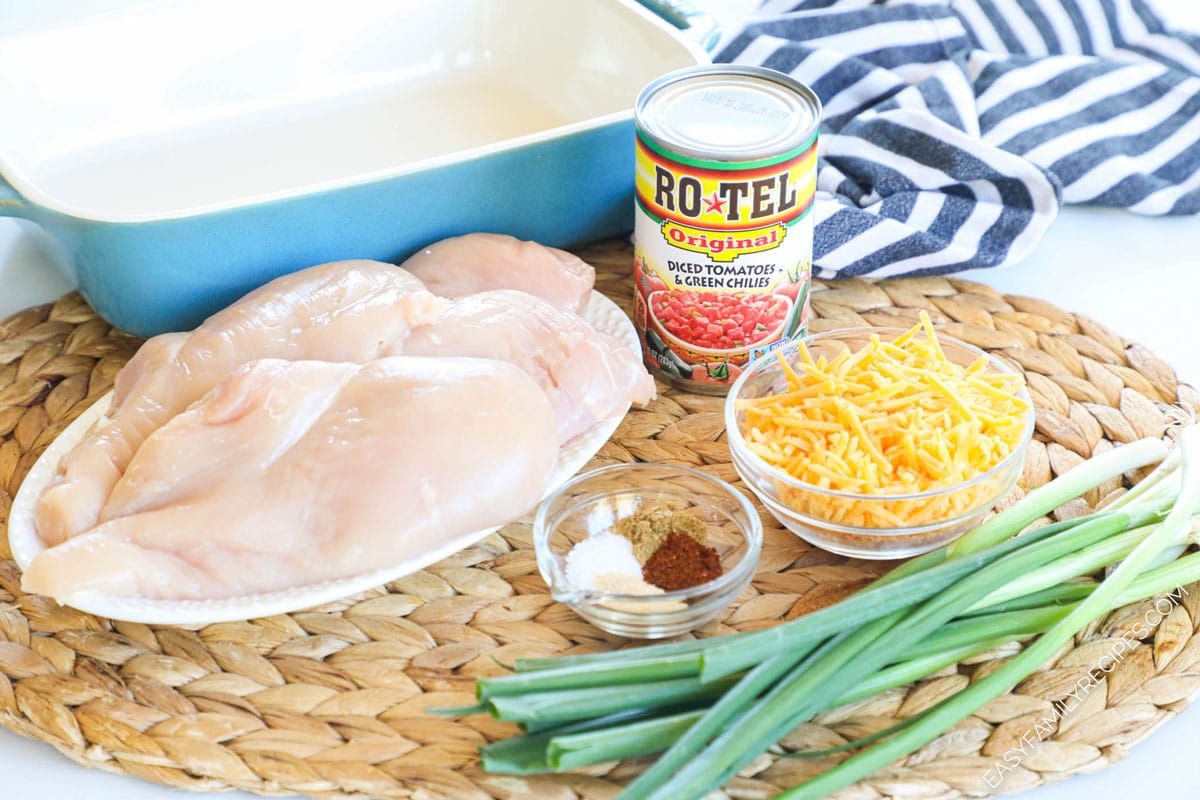 Ingredients to make cheesy Rotel chicken bake including chicken breasts, cheese, spices, original Rotel, and green onions