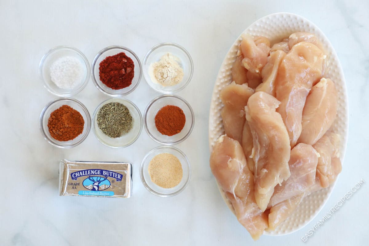 Ingredients to make blackened chicken including spices, butter, and chicken tenders.