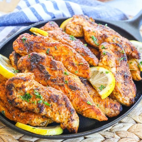 Blackened chicken tenders with lemon on a skillet