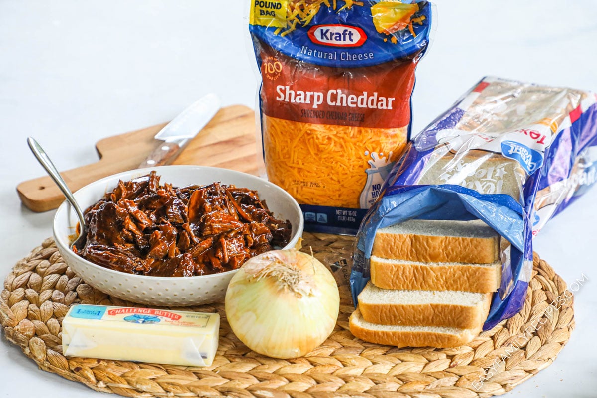 Ingredients for Brisket Grilled Cheese- Beef brisket, shredded cheddar, caramelized onions, texas toast, butter