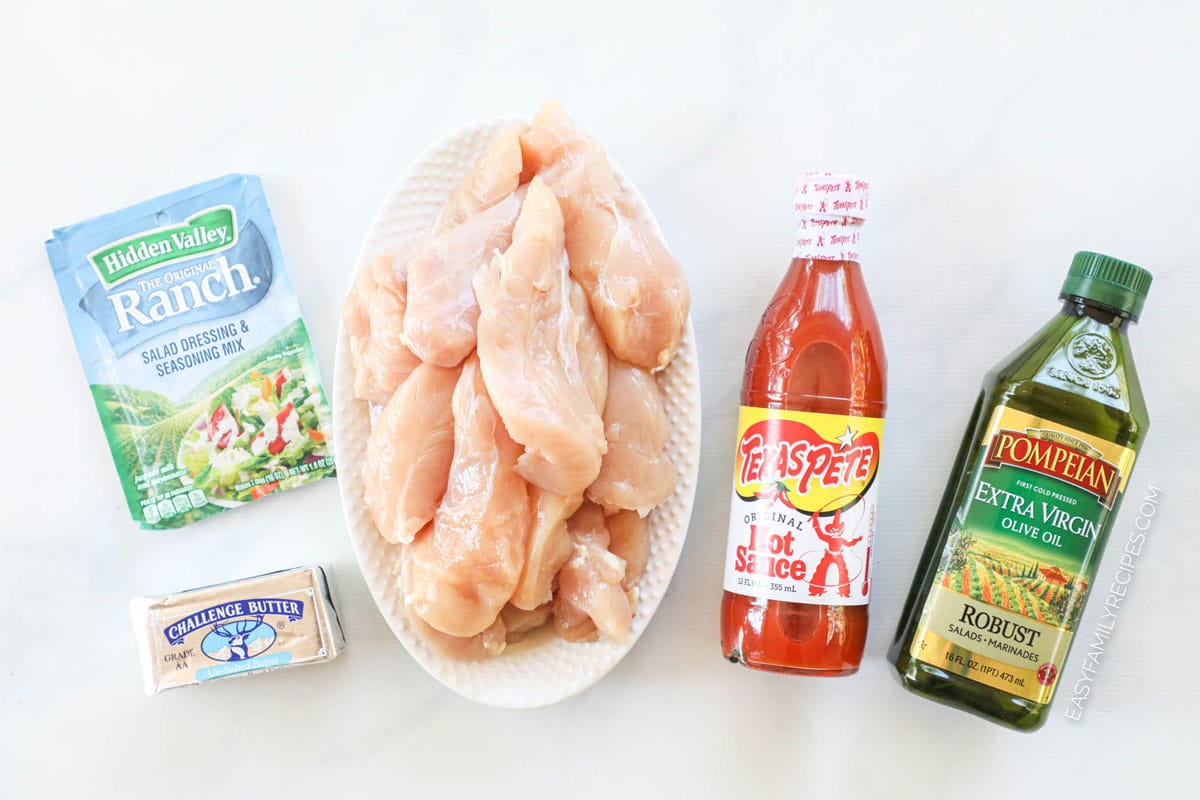 Ingredients to make buffalo chicken tenders including chicken strips, ranch seasoning, hot sauce, and butter