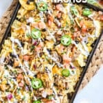 sheet pan with loaded carnitas nachos