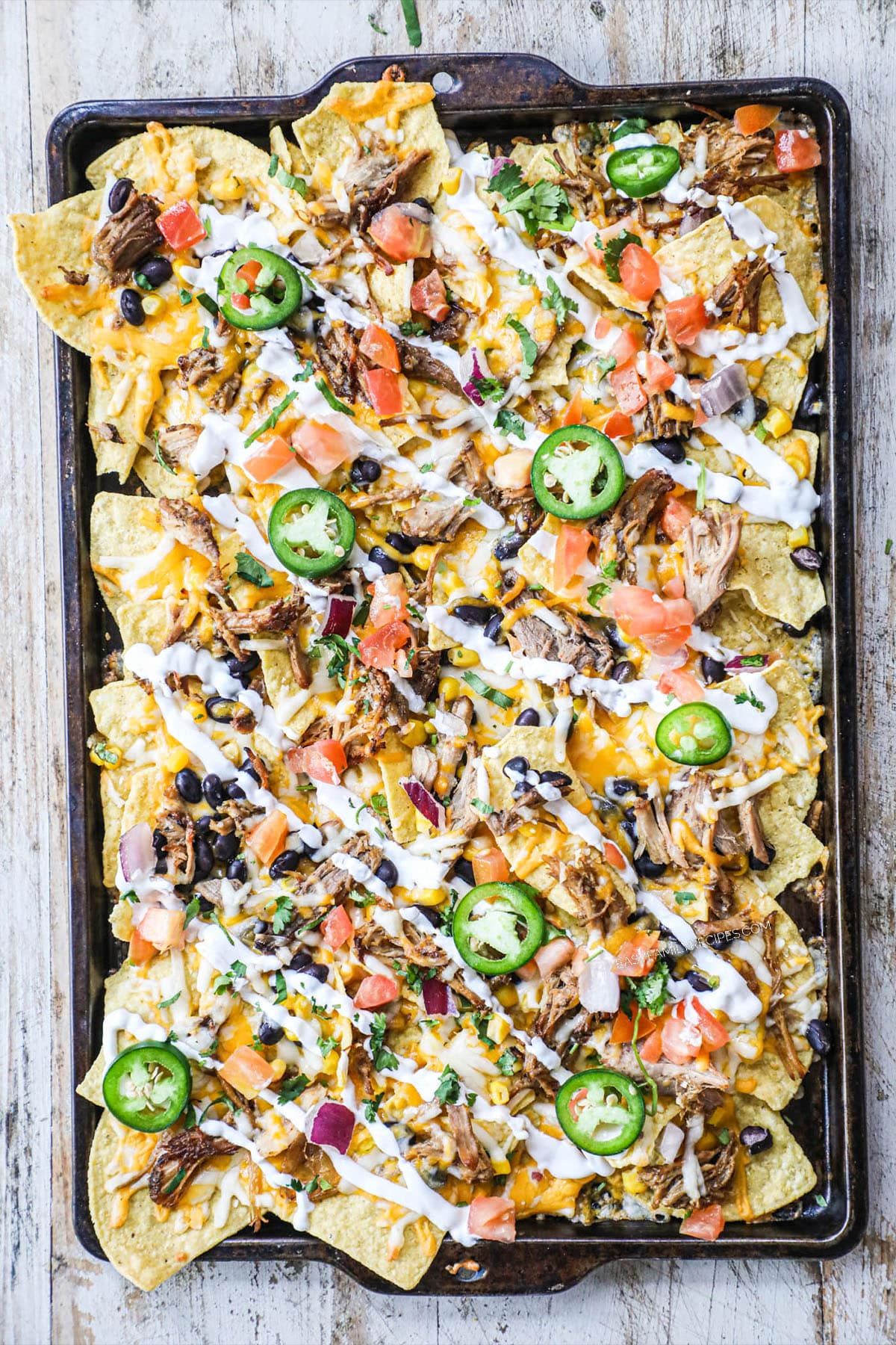 sheet pan with loaded carnitas nachos