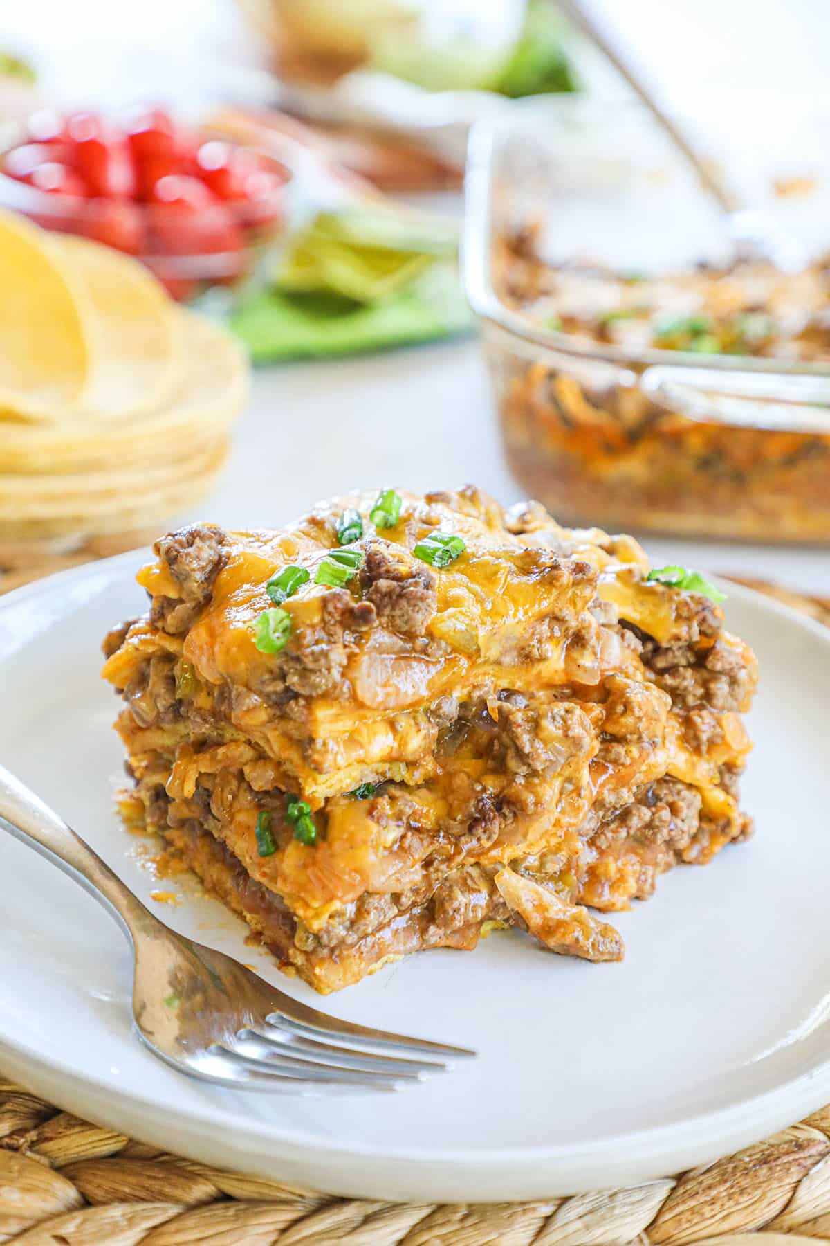 Image of single portion of baked enchilada casserole on a dish.