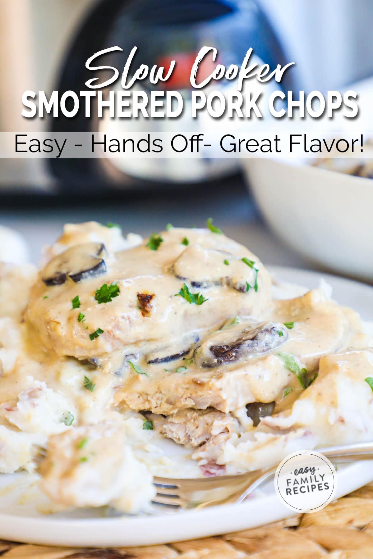 Creamy smothered pork chops on a platter ladled with gravy