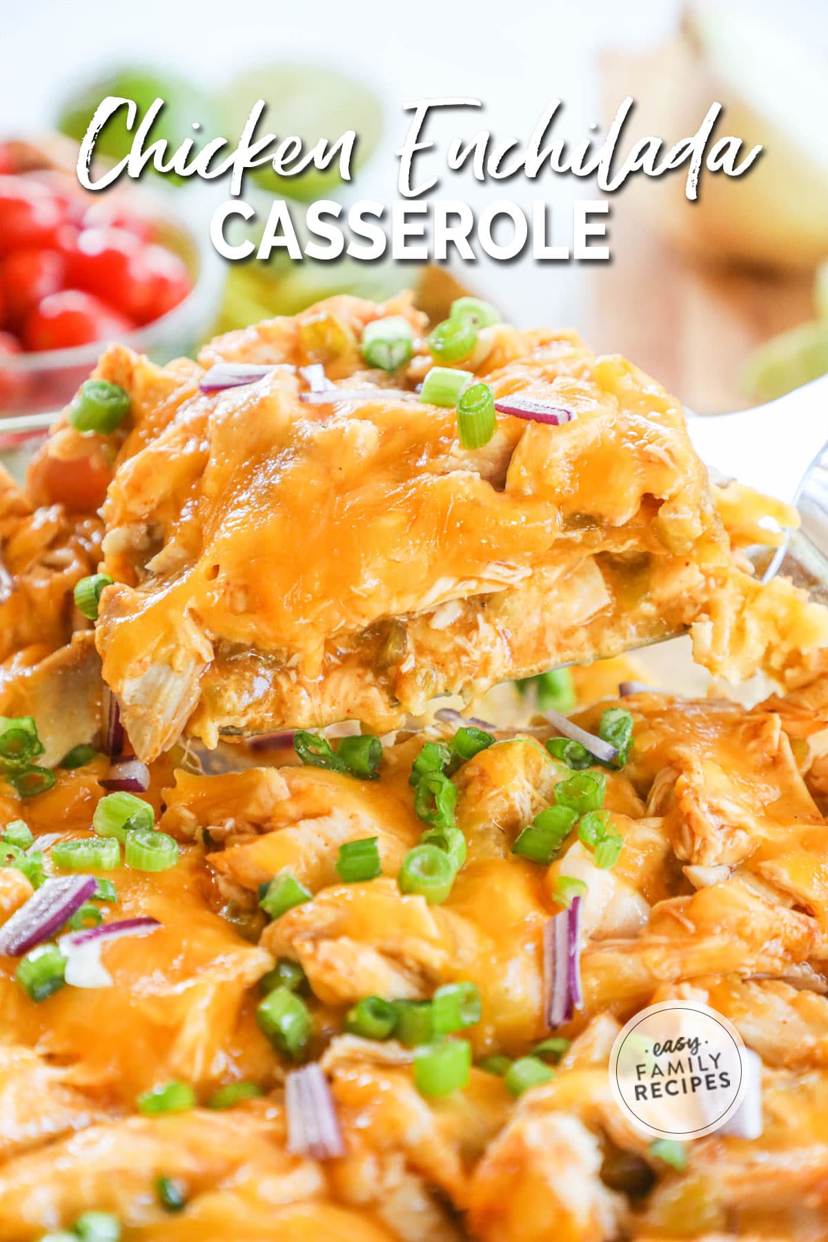 Close up of chicken enchilada casserole being lifted out of a pan.