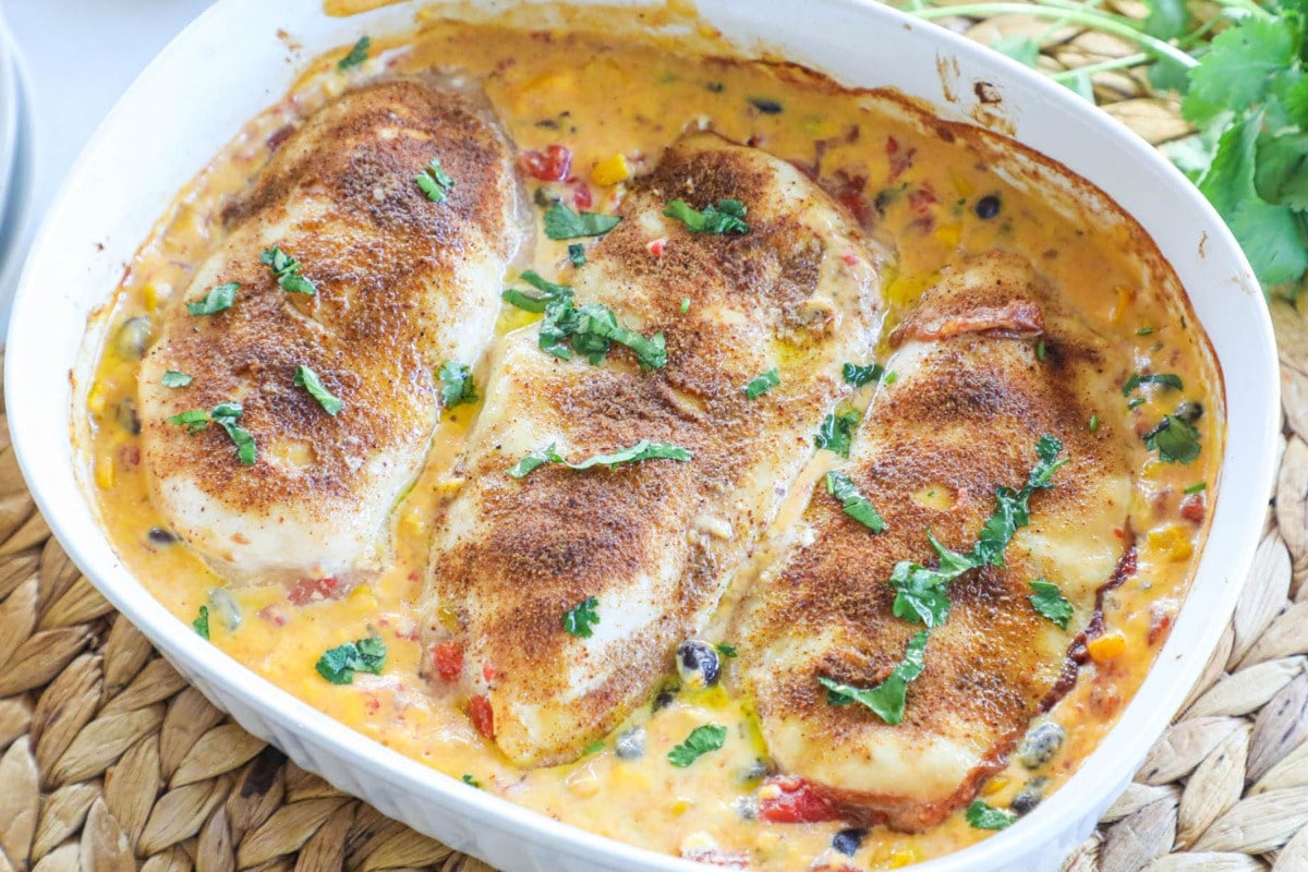 Baked Queso Chicken in baking dish ready to serve for an easy dinner.