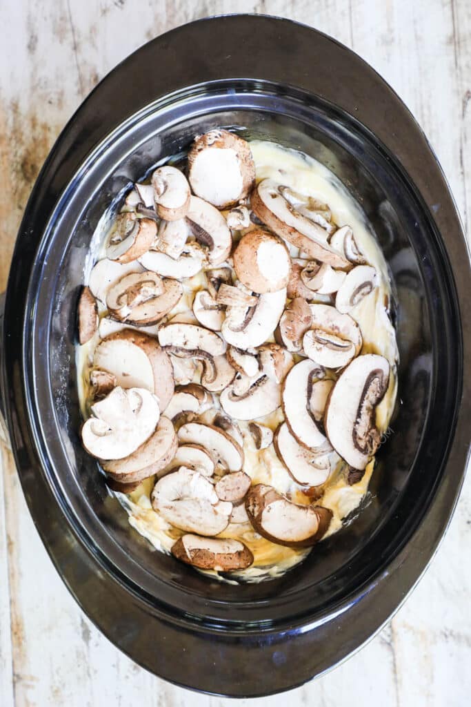 How to make crockpot smothered pork chops step 3: combine soup and stir in mushrooms. Make sure that the pork chops are covered in the soups.