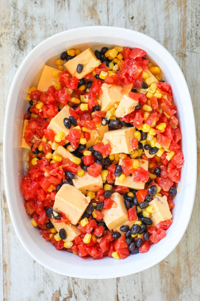 How to make Queso chicken step 2: add rotel tomatoes, balck beans and rice.