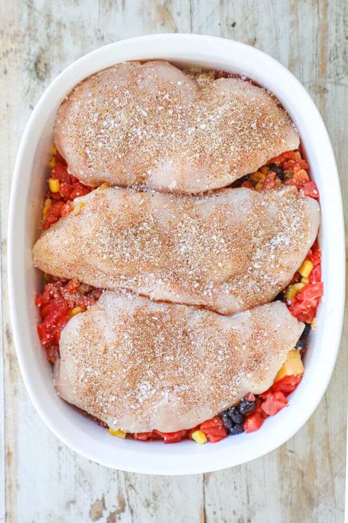 How to make Queso chicken step 3: season the chicken breast and place on top of the cheese mixture.