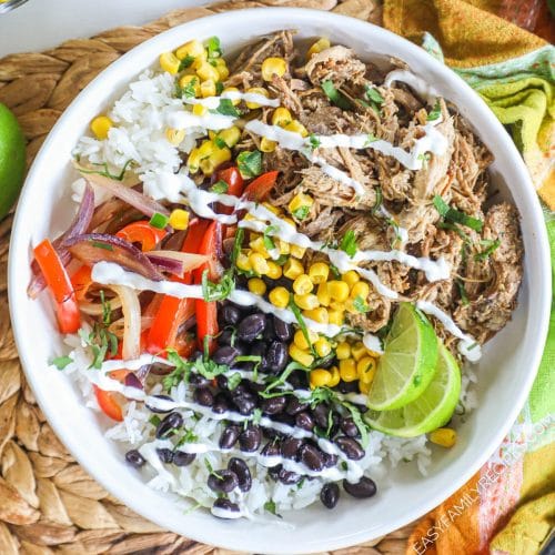 A pork carnitas bowl with pico de gallo, avocado, corn, black beans, and sour cream.