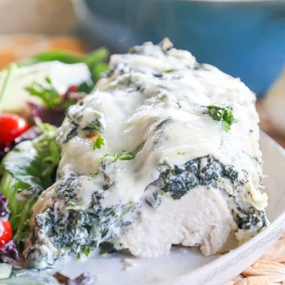Tender juicy chicken breast baked with creamy cheese and spinach on top