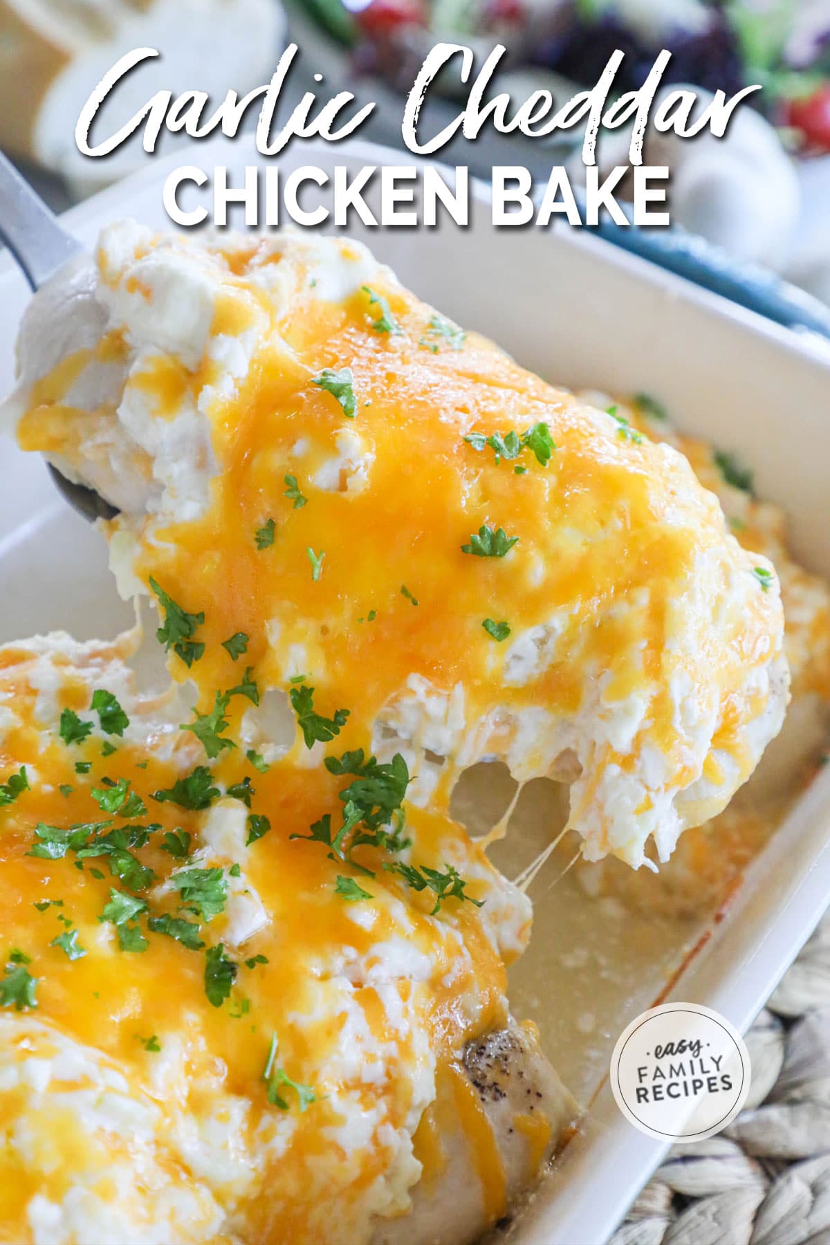 A juicy baked chicken breast with a creamy garlic cheddar cheese topping