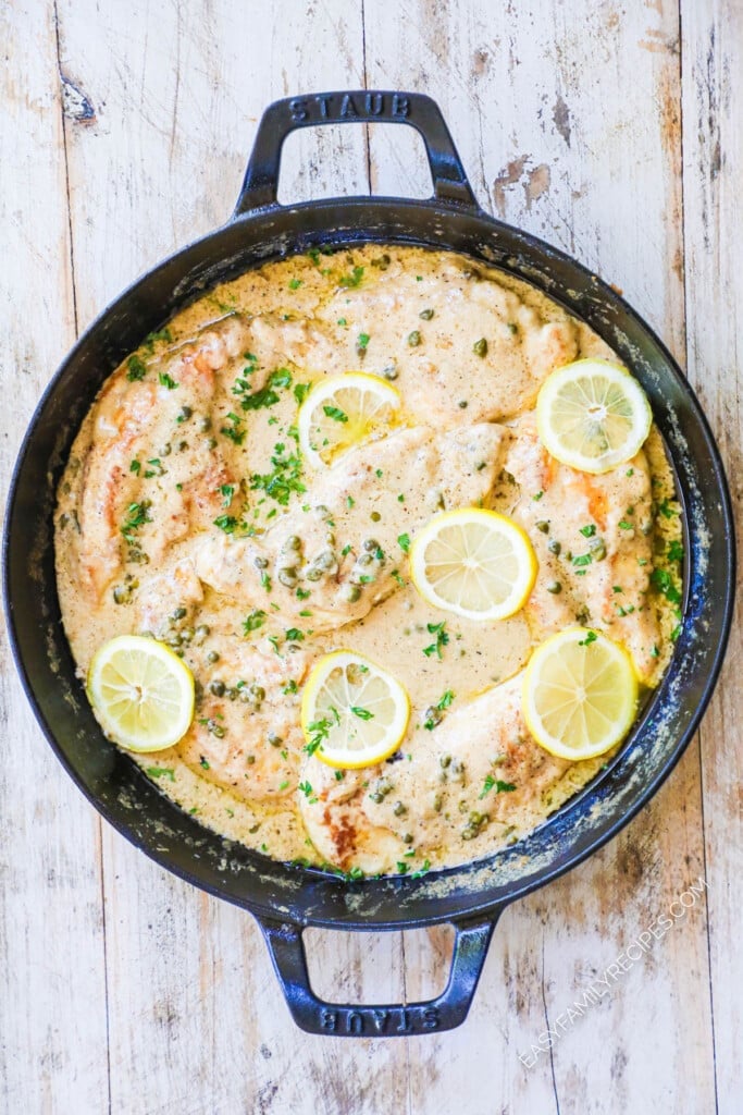 How to make Creamy Chicken Piccata step 4: Simmer chicken in sauce until cooked through then garnish with lemon and parsley.