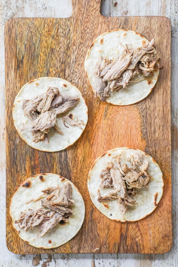How to Make pork carnitas street tacos step 2: Add crispy pork carnitas meat to the taco shell.