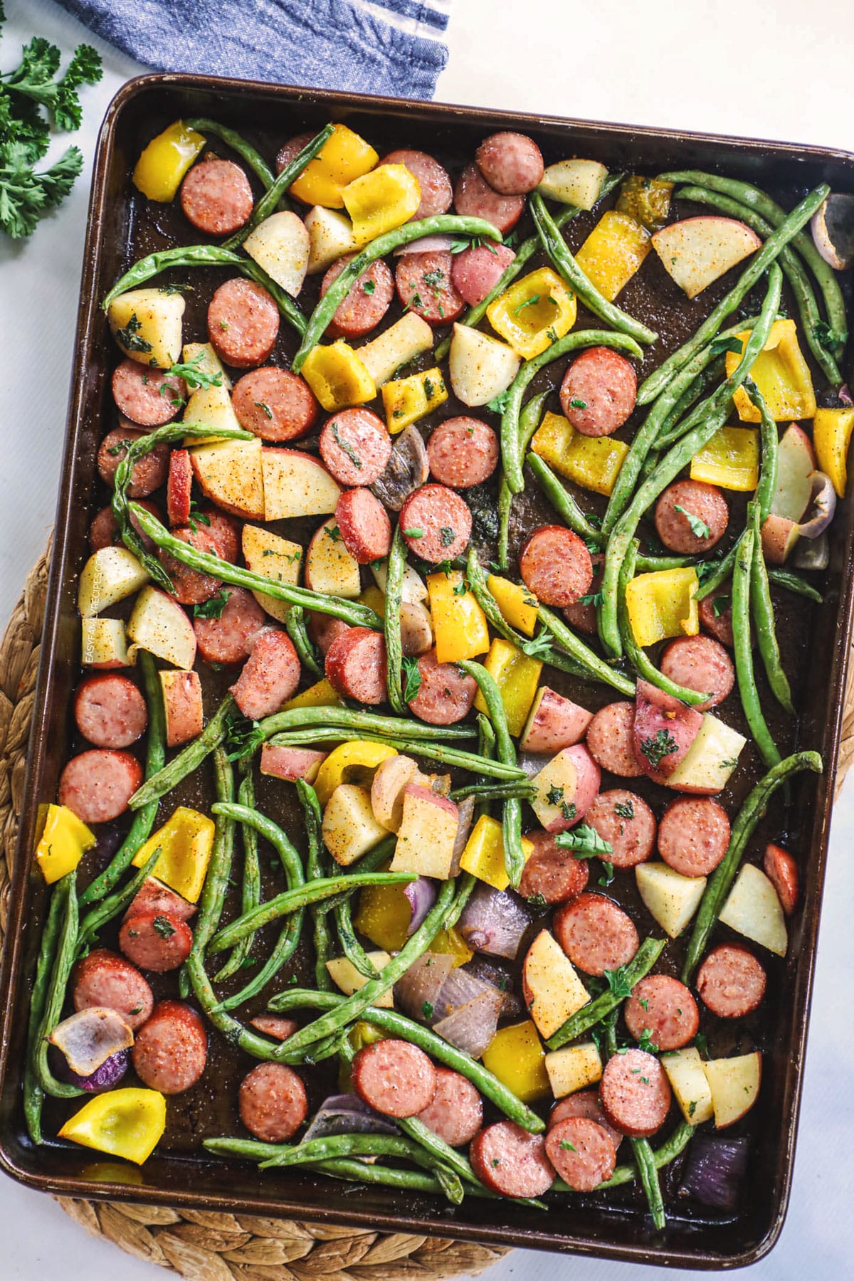 Cajun Smoked Sausage and Roasted Potatoes and vegetables prepared on a sheet pan.