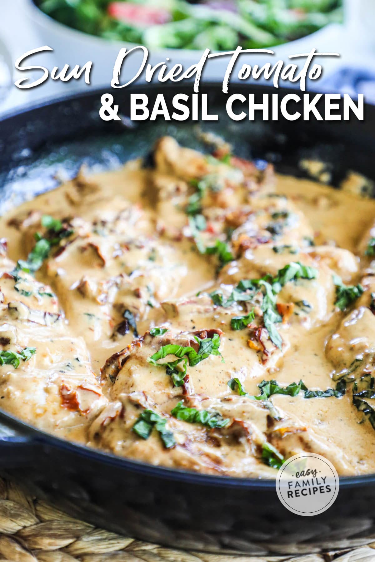 close up of the chicken in a cream sauce with fresh basil in a skillet.