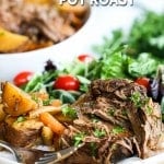 Pot roast served on plate with potatoes, carrots and salad